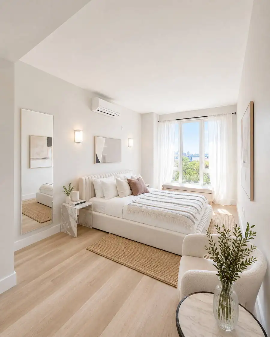 Primary bedroom with soft daylight and natural materials