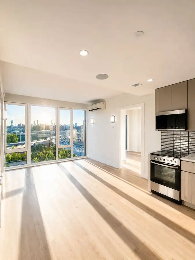 Waterfront living area with sun and kitchen view