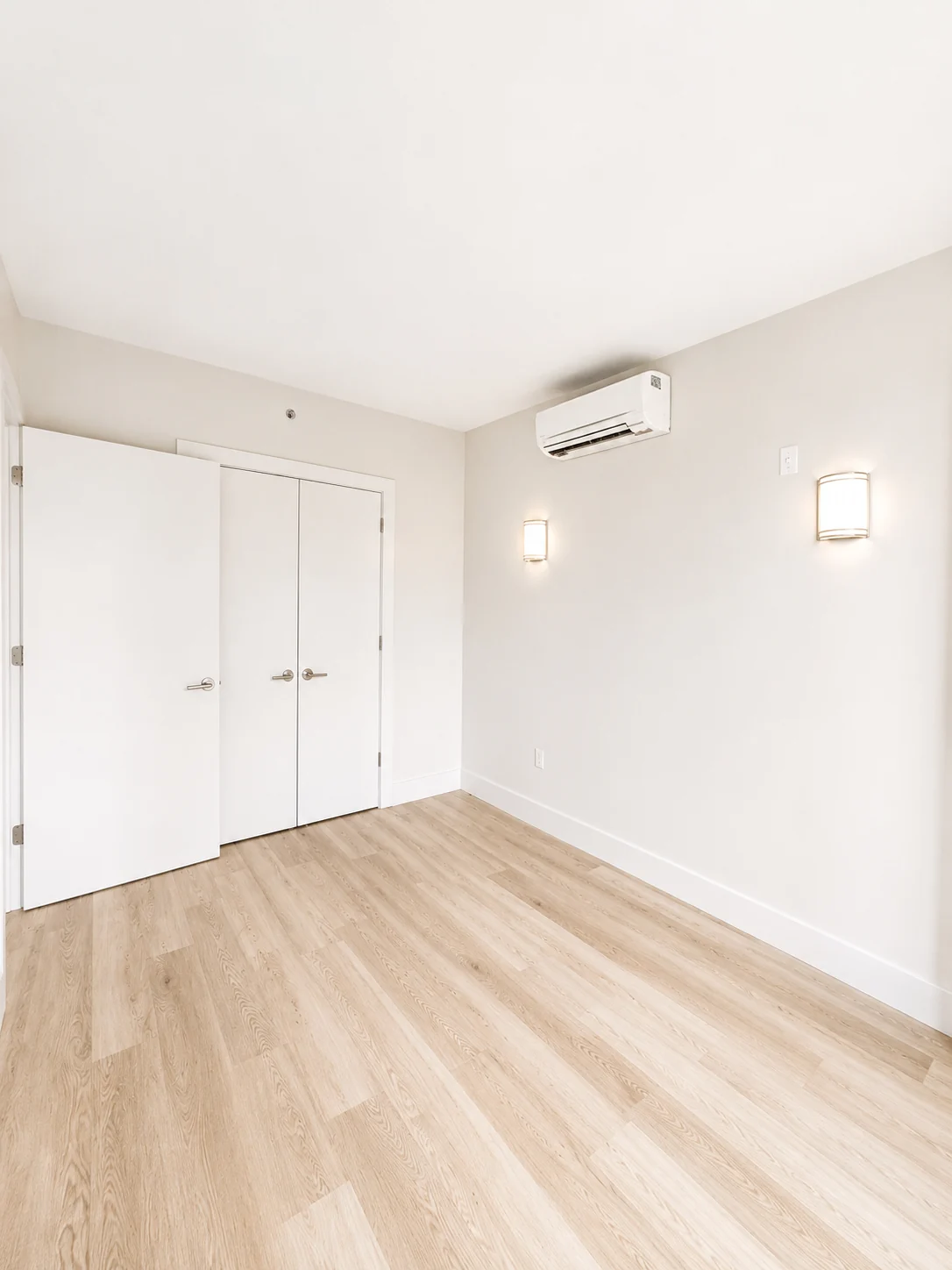 Residence 601 bedroom with closet and wall lighting